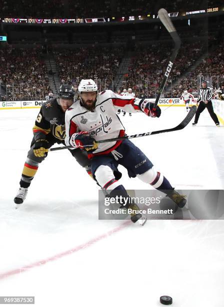 Alex Ovechkin of the Washington Capitals is pursued by Brayden McNabb of the Vegas Golden Knights during the first period in Game Five of the 2018...