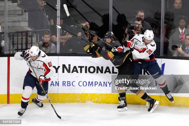 Colin Miller of the Vegas Golden Knights is checked by Lars Eller of the Washington Capitals during the first period in Game Five of the 2018 NHL...