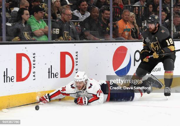 John Carlson of the Washington Capitals falls to the ice in front of James Neal of the Vegas Golden Knights during the first period of Game Five of...