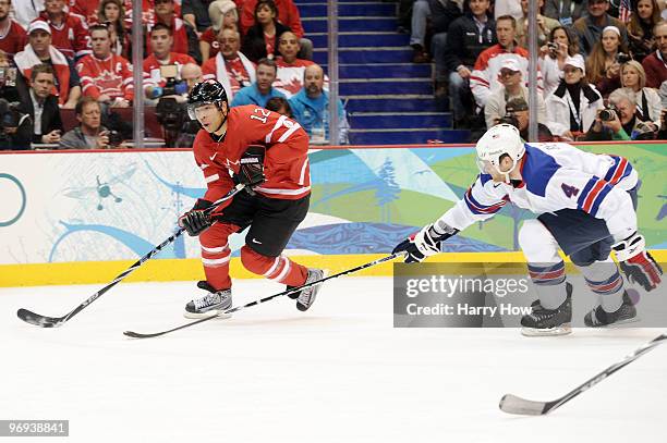 Jarome Iginla of Canada skates with the puck as Tim Gleason of the United States chases him during the ice hockey men's preliminary game between...