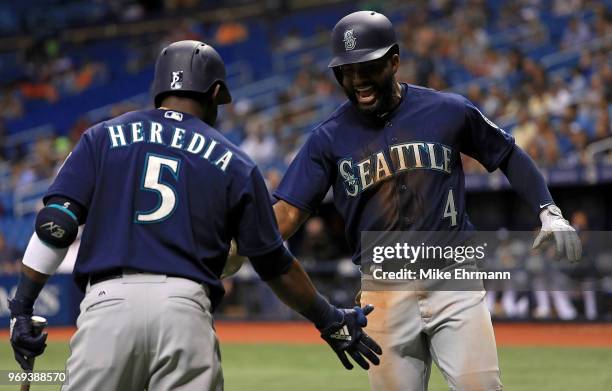 Denard Span of the Seattle Mariners celebrates a home run in the third inning with Guillermo Heredia during a game against the Tampa Bay Rays at...