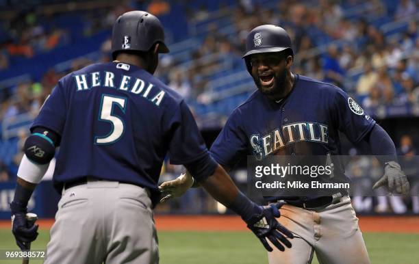 Denard Span of the Seattle Mariners celebrates a home run in the third inning with Guillermo Heredia during a game against the Tampa Bay Rays at...