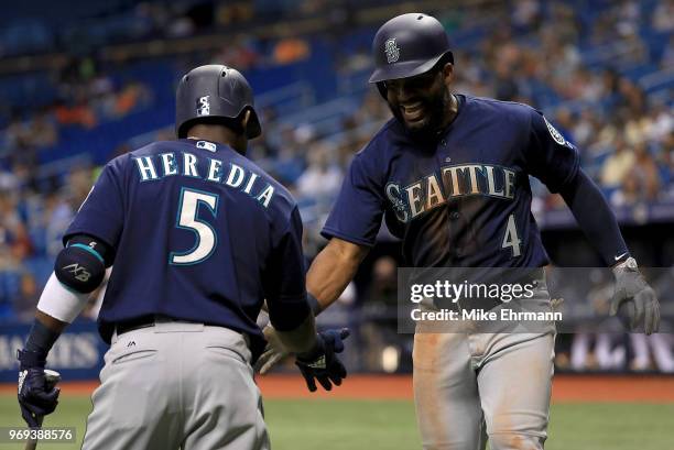 Denard Span of the Seattle Mariners celebrates a home run in the third inning with Guillermo Heredia during a game against the Tampa Bay Rays at...