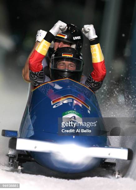 Germany 1 with Andre Lange and Kevin Kuske of Germany celebrate their gold medal during the Two-Man Bobsleigh Heat 4 on day 10 of the 2010 Vancouver...
