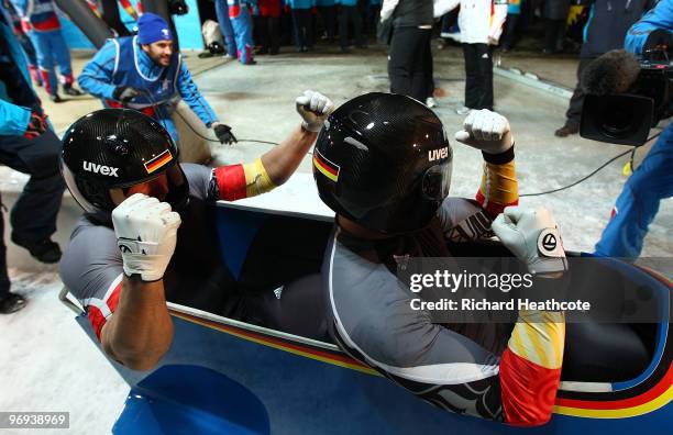 Germany 1 with Andre Lange and Kevin Kuske celebrate their gold medal and Lange's fourth during the Two-Man Bobsleigh Heat 4 on day 10 of the 2010...