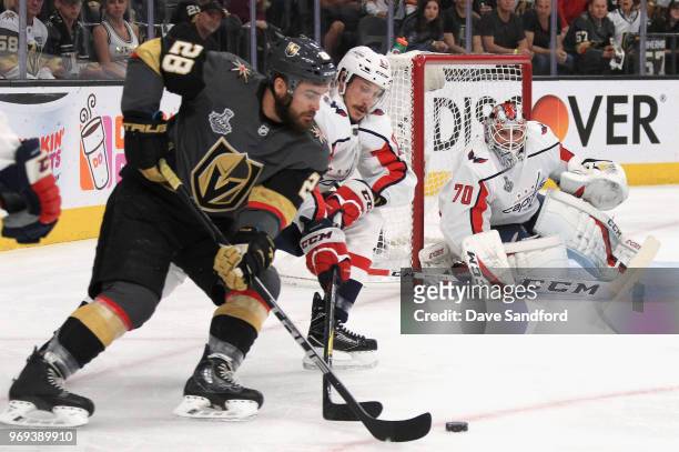 Goaltender Braden Holtby of the Washington Capitals watches as teammate Jay Beagle battles with William Carrier of the Vegas Golden Knights during...
