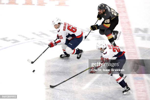 Andre Burakovsky of the Washington Capitals is pursued by William Carrier of the Vegas Golden Knights during the first period in Game Five of the...