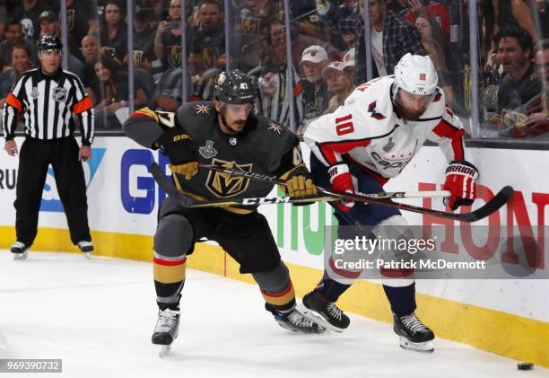 Luca Sbisa of the Vegas Golden Knights and Brett Connolly of the Washington Capitals vie for the puck along the end boards in the second period of...