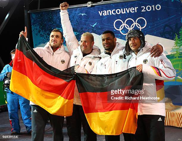 Germany 1 with Andre Lange and Kevin Kuske celebrate their gold medal with silver medalists Germany 2 Richard Adjei and Thomas Florschuetz after the...