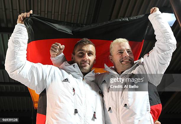 Germany 1 with Andre Lange and Kevin Kuske celebrate their gold medal and Lange's fourth during the Two-Man Bobsleigh Heat 4 on day 10 of the 2010...