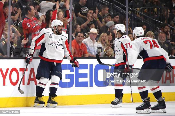 Alex Ovechkin of the Washington Capitals is congratulated by his teammates T.J. Oshie and John Carlson after scoring a second-period goal against the...