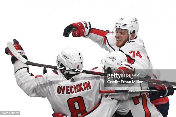 Alex Ovechkin of the Washington Capitals is congratulated by his teammates T.J. Oshie and John Carlson after scoring a second-period, power-play goal...