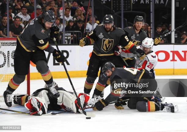 Colin Miller, Tomas Tatar, Cody Eakin and Luca Sbisa of the Vegas Golden Knights defend the low slot area against Lars Eller of the Washington...