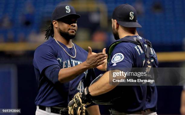 Alex Colome and David Freitas of the Seattle Mariners celebrate winning a game against the Tampa Bay Rays at Tropicana Field on June 7, 2018 in St...