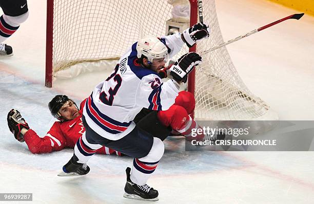S forward Chris Drury scores against Canada's defender Dan Boyle during the Men's preliminary Ice Hockey match Canada against USA at the XXI Winter...