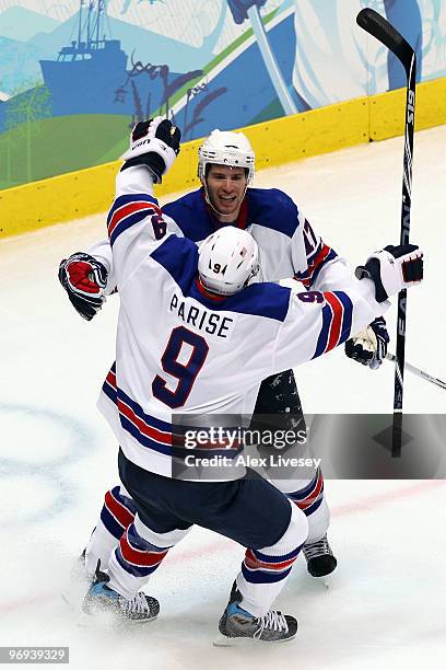 Zach Parise of the United States and Ryan Kesler of the United States celebrate after Kesler scored an empty net goal in the third period during the...