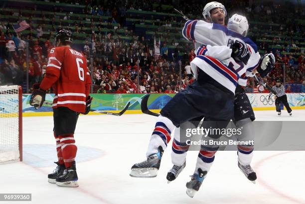 Zach Parise of the United States and Ryan Kesler of the United States celebrate after Kesler scored an empty net goal in the third period during the...