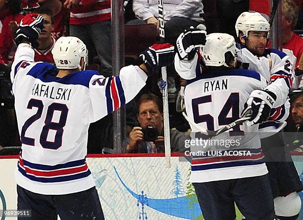 S forward Chris Drury celebrates with teammates USA's defender Brian Rafalski and USA's forward Bobby Ryan after scoring a goal during the Men's...
