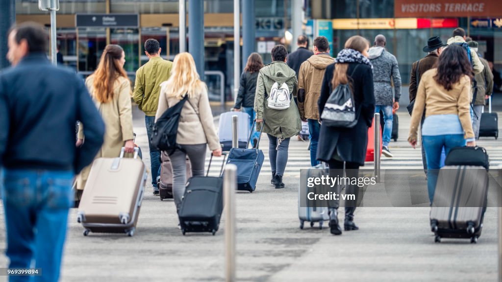 Menschen zu Fuß in Richtung Flughafen