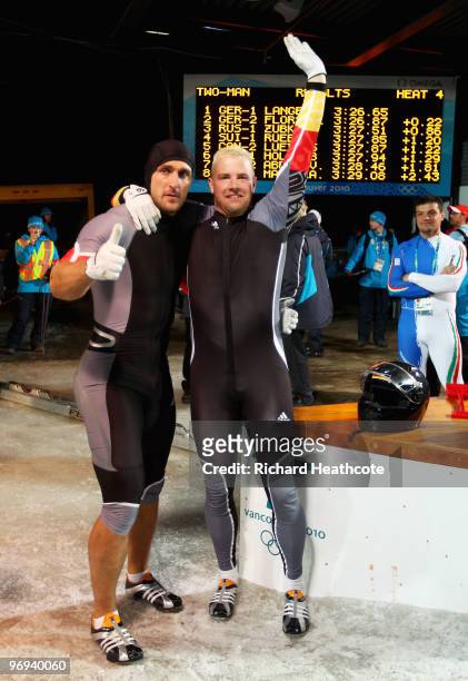 Germany 1 with Andre Lange and Kevin Kuske celebrate their gold medal and Lange's fourth during the Two-Man Bobsleigh Heat 4 on day 10 of the 2010...