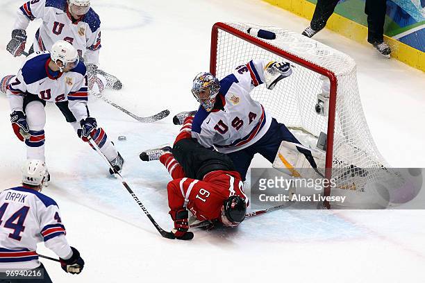 Rick Nash of Canada falls in front of goalkeeper Ryan Miller of the United States during the ice hockey men's preliminary game between Canada and USA...