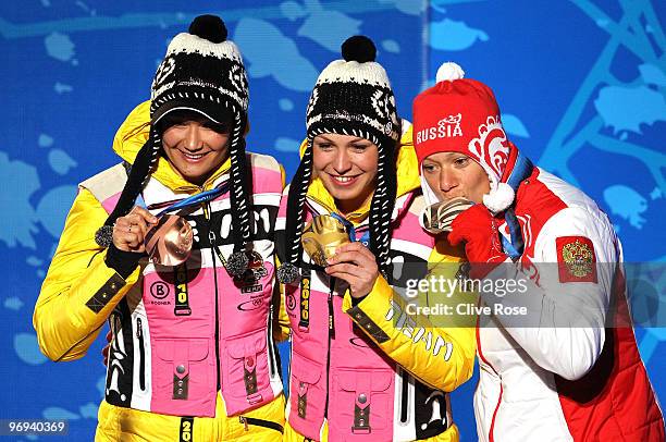 Simone Hauswald of Germany celebrates her Bronze medal, Magdalena Neuner of Germany Gold and Olga Zaitseva of Russia Silver during the medals...