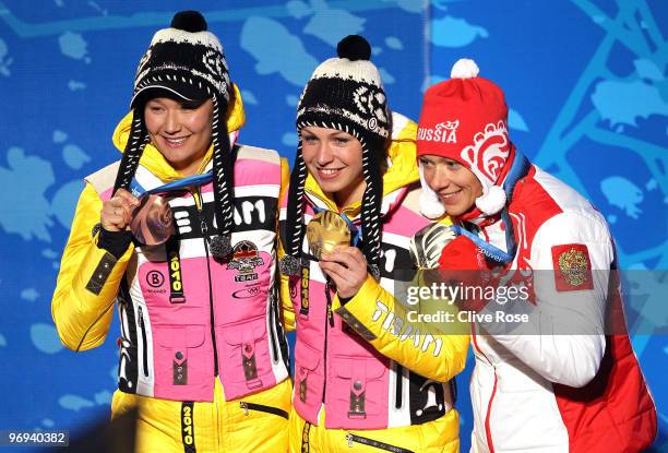 Simone Hauswald of Germany celebrates her Bronze medal, Magdalena Neuner of Germany Gold and Olga Zaitseva of Russia Silver during the medals...