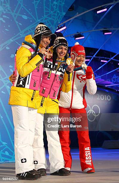 Simone Hauswald of Germany celebrates her Bronze medal, Magdalena Neuner of Germany Gold and Olga Zaitseva of Russia Silver during the medals...