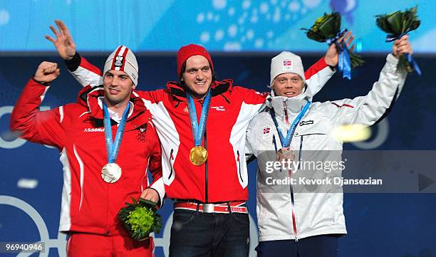 Andreas Matt of Austria celebrates his Silver medal, Michael Schmid of Switzerland Gold and Audun Groenvold of Norway Bronze during the medal...