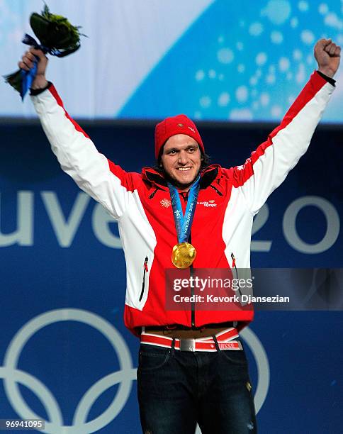 Michael Schmid of Switzerland celebrates his Gold medal during the medal ceremony in the Men�s Freestyle Skiing Ski Crosson day 10 of the Vancouver...