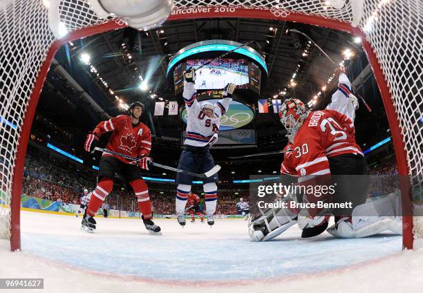 Zach Parise and Jamie Langenbrunner of the United States celebrate after Langenbrunner scored a power play goal in the third period as goalie Martin...