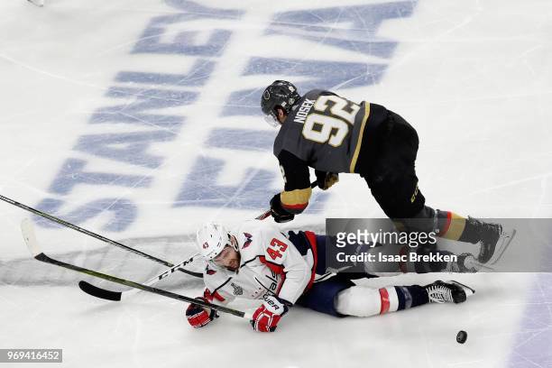 Tom Wilson of the Washington Capitals and Tomas Nosek of the Vegas Golden Knights battle for the puck during the third period in Game Five of the...