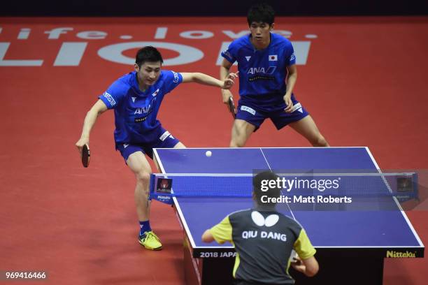 Jin Ueda of Japan competes with men's doubles partner Maharu Yoshimura of Japan against Benedikt Duda of Germany and Dang Qiu on day one of the ITTF...