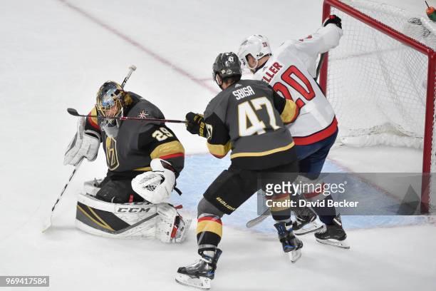 Lars Eller of the Washington Capitals scores a goal with Luca Sbisa and Marc-Andre Fleury of the Vegas Golden Knights defending in Game Five of the...