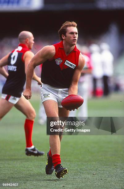 David Neitz of the Demons handpasses during the round two AFL match between Melbourne Demons and Collingwood Magpies, 1996 in Melbourne, Australia.