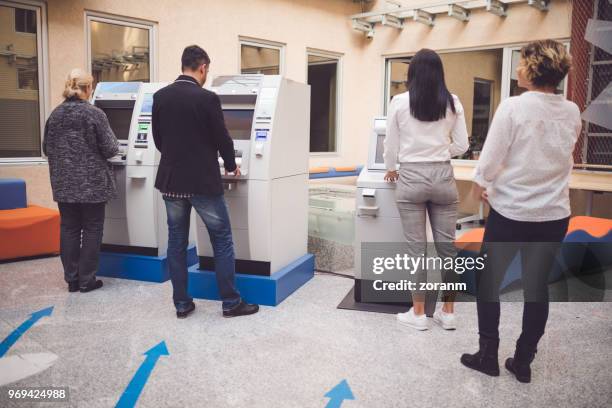 people withdrawing cash from an atm - pin code stock pictures, royalty-free photos & images