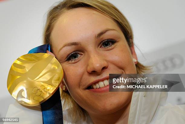 German Magdalena Neuner poses with her gold medal for the Women's Biathlon 12.5km mass start event of the Vancouver 2010 Winter Olympics at Whistler...