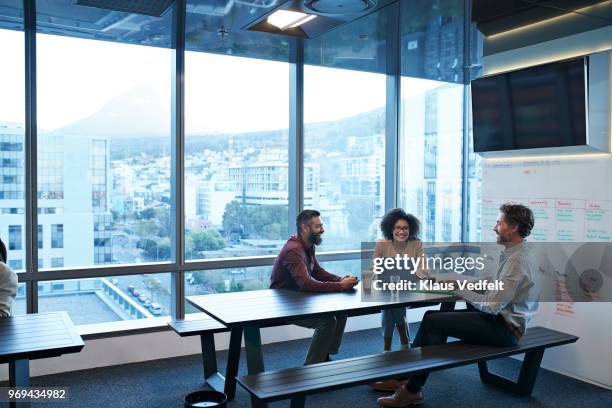 business people talking and laughing while having coffee break - cape town buildings stock pictures, royalty-free photos & images