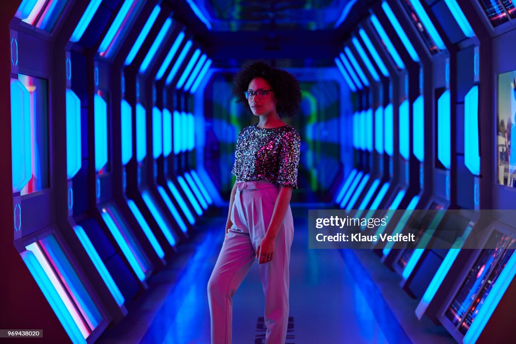 Portrait of young businesswoman looking in camera in spaceship like corridor