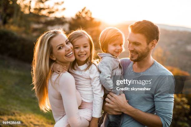 portrait of loving family in nature at sunset. - idol of the sun stock pictures, royalty-free photos & images