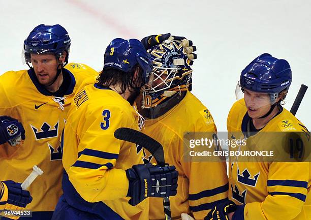 Swedish goal keeper Henrik Lundqvist is congratulated by team mate defence Douglas Murray following their win in the Men's preliminary Ice Hockey...