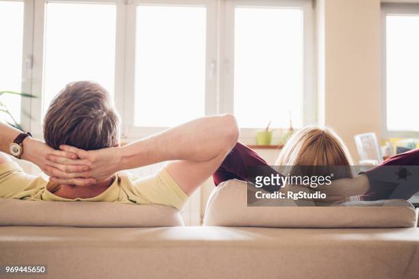 young couple resting at home - lazy husband stock pictures, royalty-free photos & images