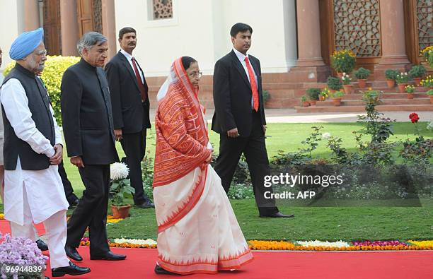 Indian President Pratibha Patil and Prime Minister Manmohan Singh arrive for the opening of the budget session of the Indian Parliament in New Delhi...