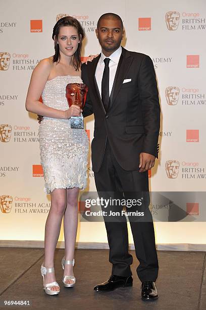 Actress Kristen Stewart with the Orange Rising Star award and actor Noel Clarke during the Orange British Academy Film Awards 2010 at the Royal Opera...