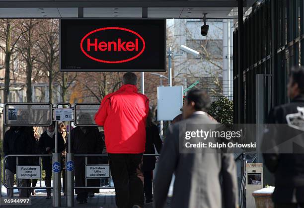 Pedestrians enter the main gate of German toiletries, cosmetics and detergent maker Henkel at the manufacturing plant on February 16, 2010 in...