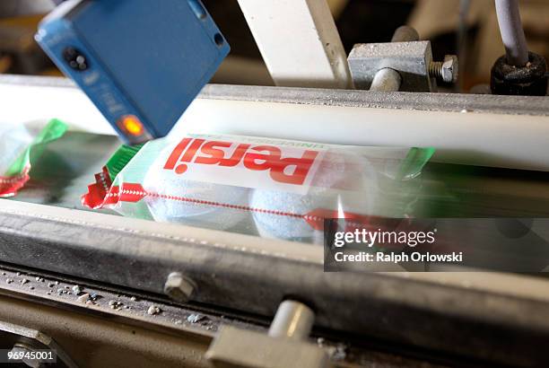 Persil detergent tabs pass a quality check at the manufacturing site of German toiletries, cosmetics and detergent maker Henkel plant on February 16,...