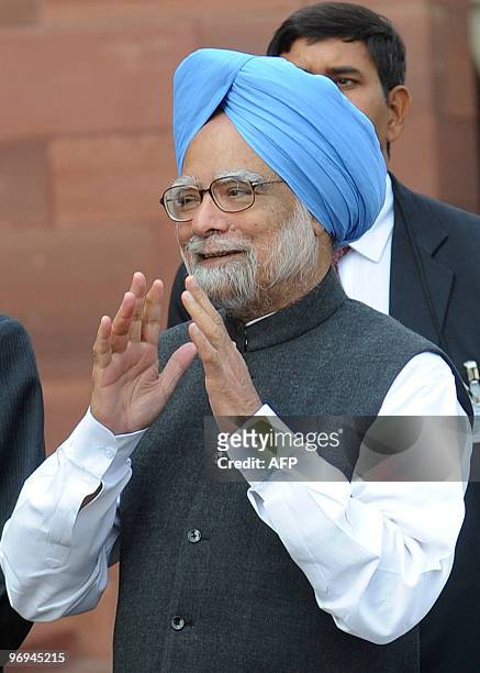Indian Prime Minister Manmohan Singh talks to journalists outside the Parliament House in New Delhi on February 22, 2010. The Budget session started...