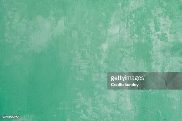 abstract background from old green concrete wall texture with grunge. vintage painted wallpaper. picture for add text message. backdrop for design art work. - farbe wand stock-fotos und bilder