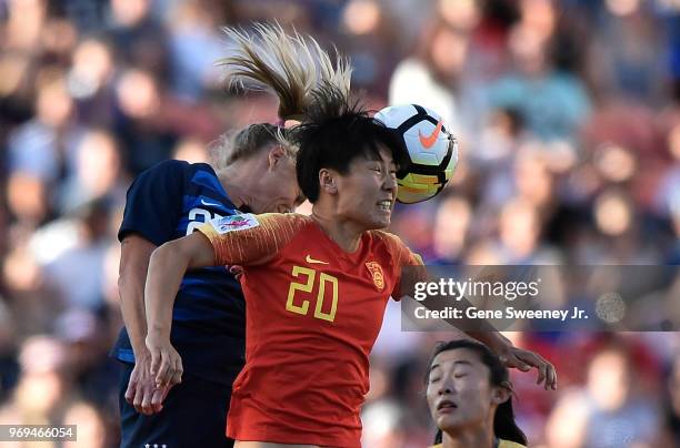 McCall Zerboni of the United States and Zhang Rui of China jump for the header try in the first half of an international friendly soccer match at Rio...