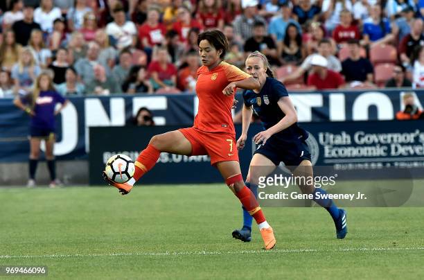 Wang Shuang of China directs the ball away from Becky Sauerbrunn of the United States in the first half of an international friendly soccer match at...